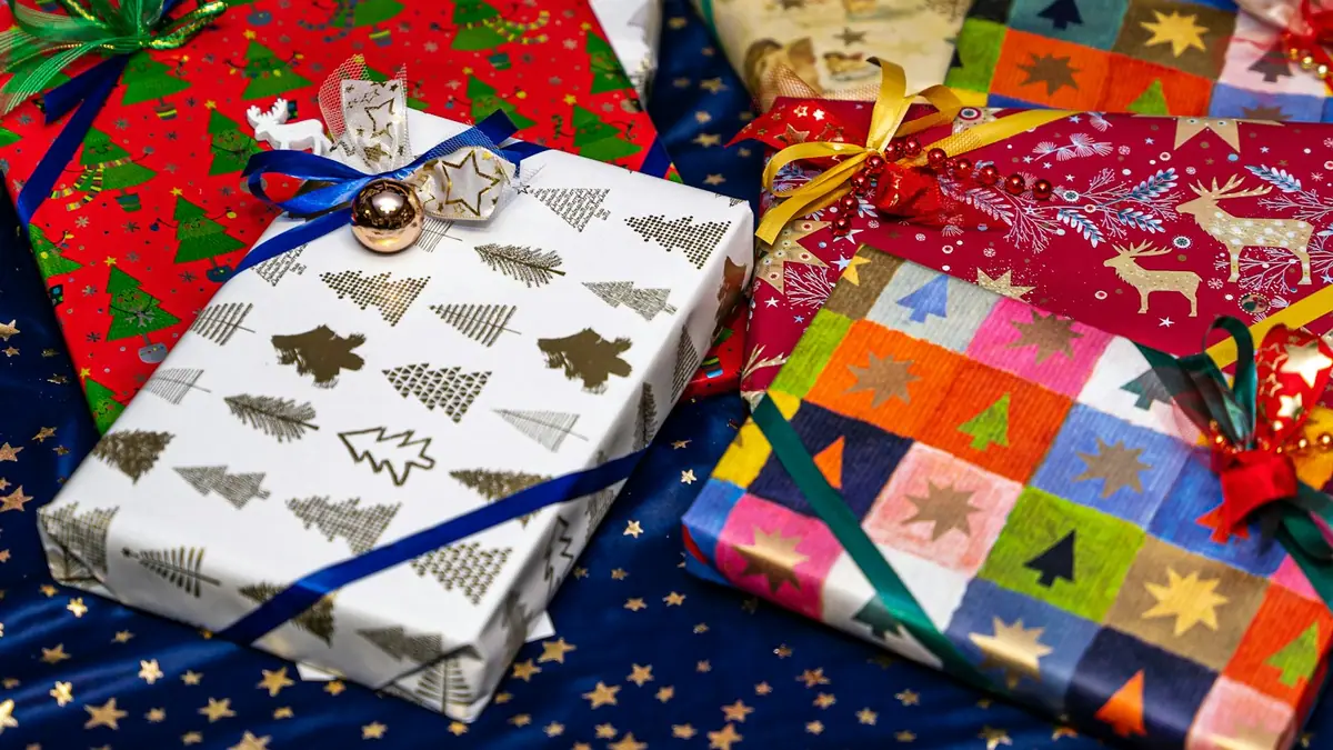 Colorful wrapped gifts piled on a table