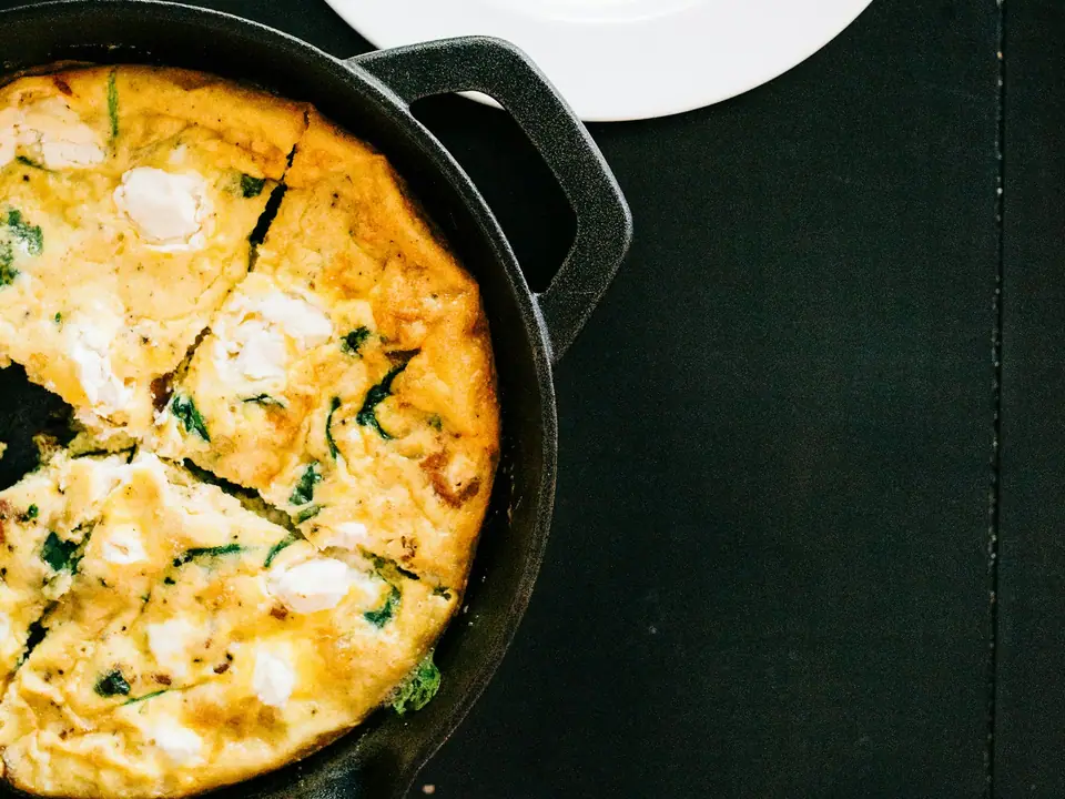 A cast iron skillet with a freshly cooked dish