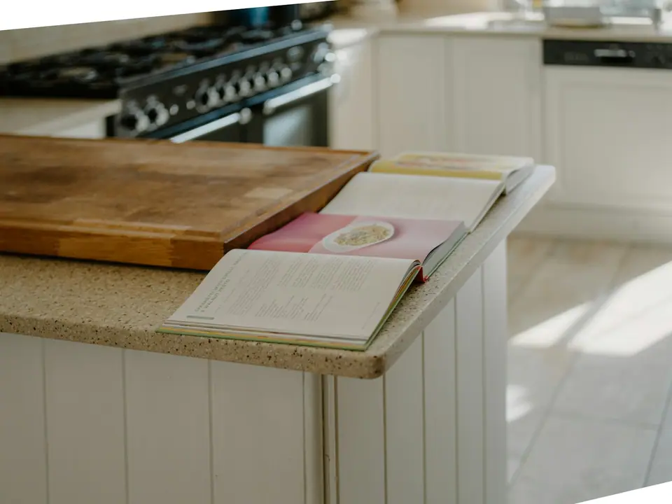 Open cookbooks resting on a kitchen counter