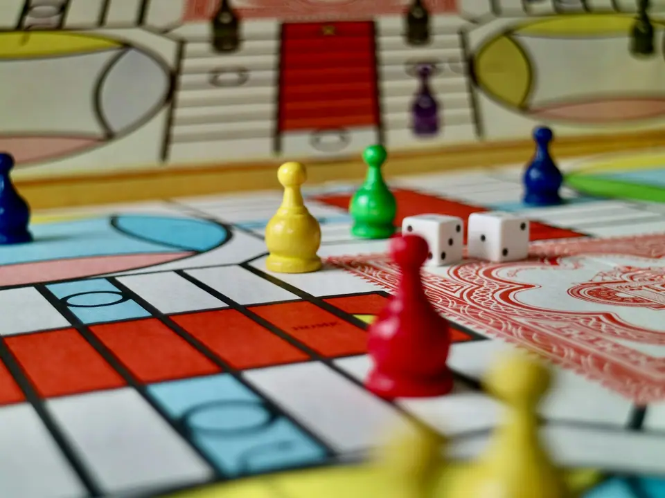 Colorful game pieces and dice on a board game