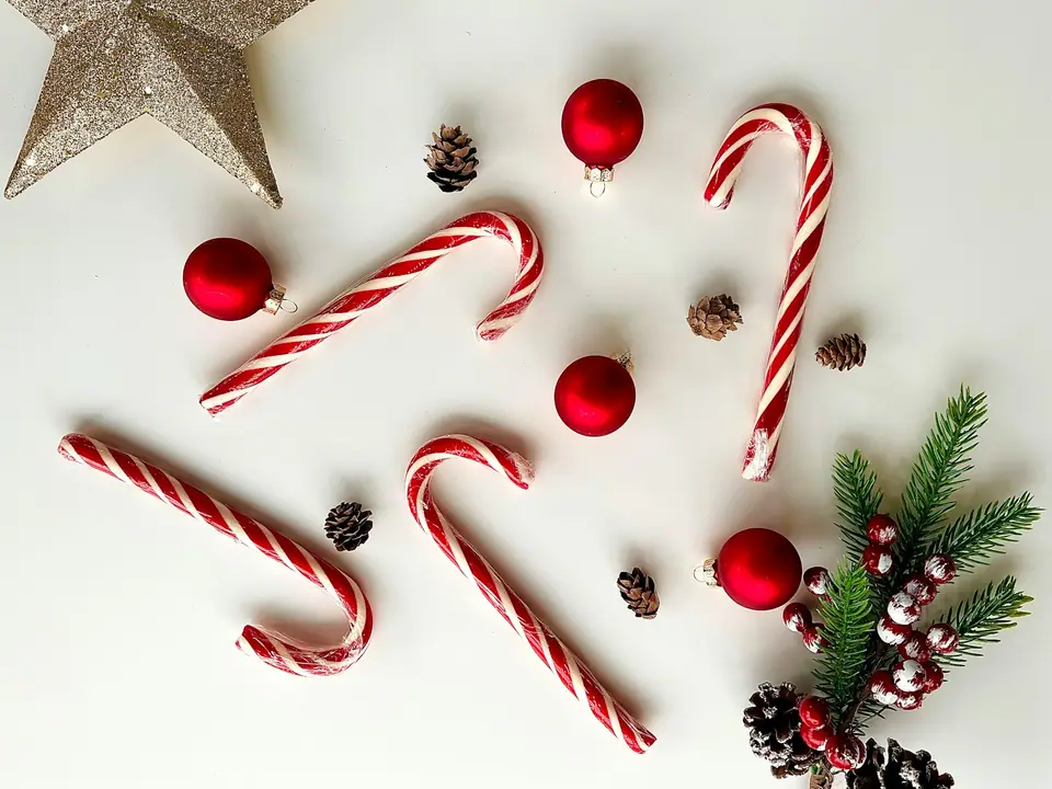 Candy canes and Christmas decorations on a white table