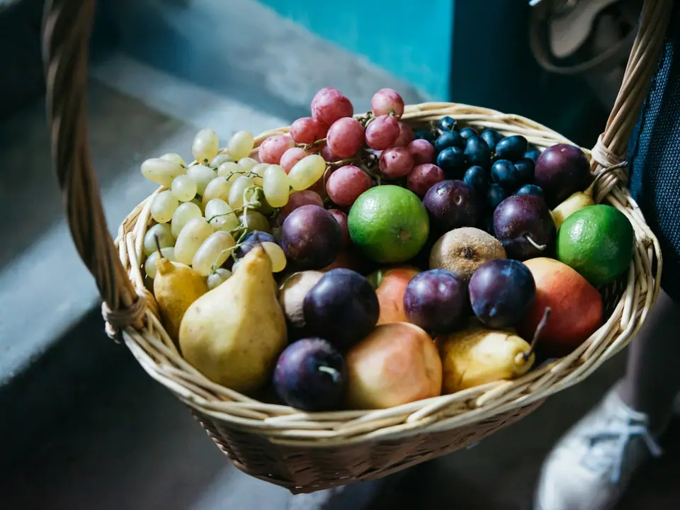 A woven basket filled with assorted fresh fruit