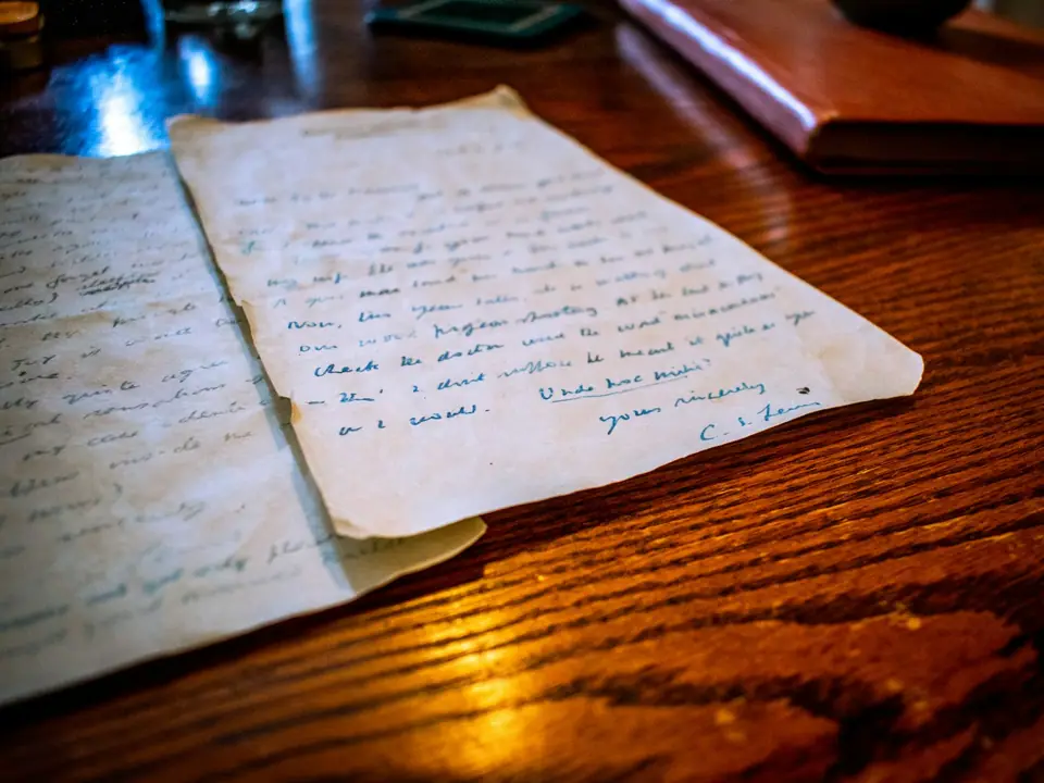 A handwritten letter resting on a wooden table