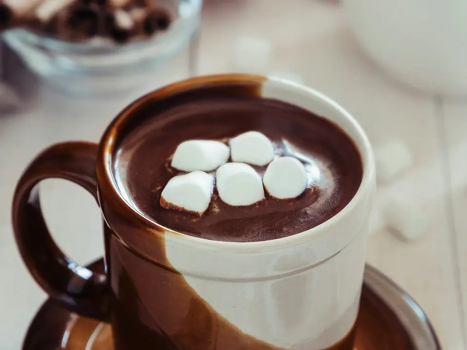 A cup of hot chocolate topped with marshmallows