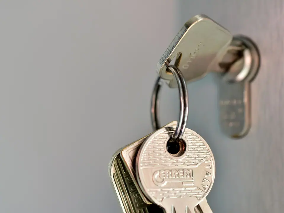 A bunch of house keys hanging on a hook