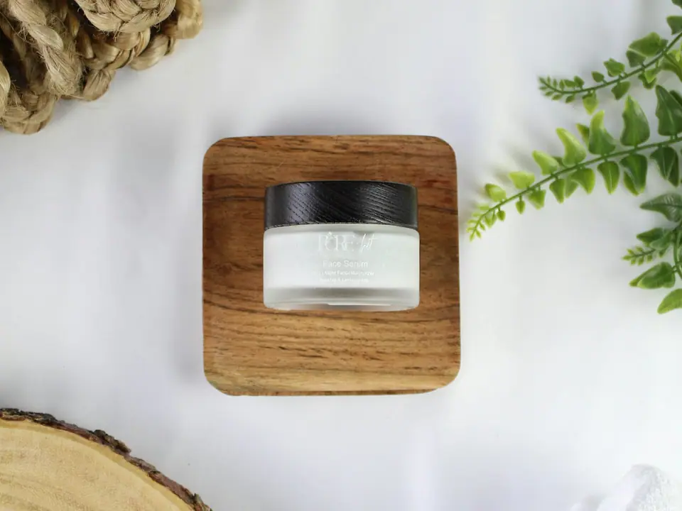 A small jar of balm on a wooden stand