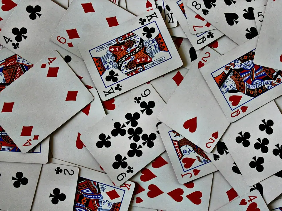 A pile of playing cards spread on a table