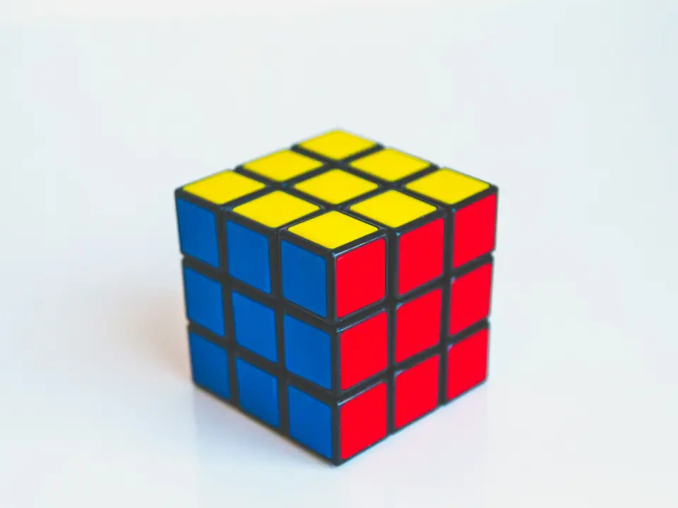 A classic 3x3 puzzle cube on a white background