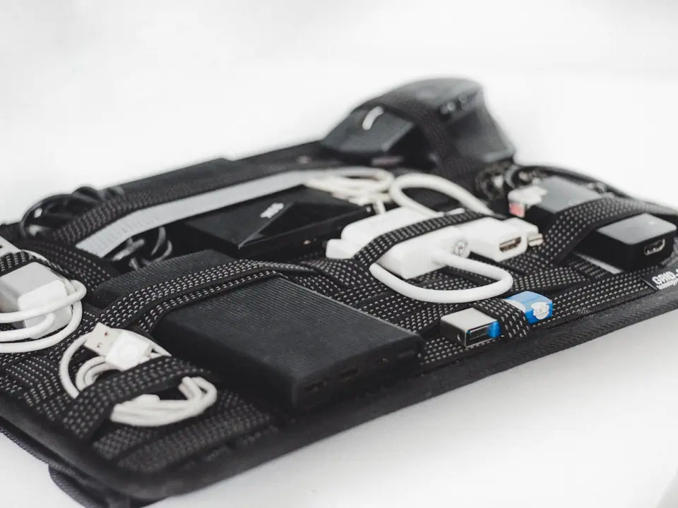 A travel organizer case holding cables and chargers
